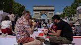 Paris' famous Champs-Elysees turned into a mass picnic blanket for an unusual meal