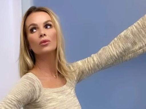 Amanda Holden braves the cold as she wows in clingy dress