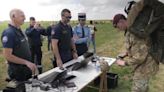 British paratroopers have passports checked after parachuting into France for D-Day event