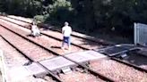 Photoshoot on railway tracks and youths play 'chicken' with trains