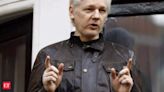 Why is Julian Assange flying to the remote Pacific island of Saipan?