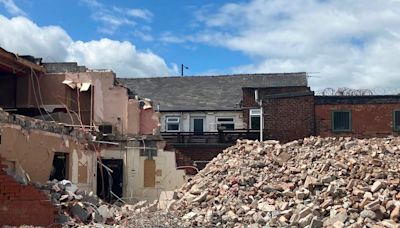 Clubbers at iconic Greater Manchester venue grab souvenirs from demolition site as it's pulled down