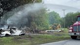 Firefighters extinguish hot spots at the UFO Welcome Center in Bowman on May 9, 2024