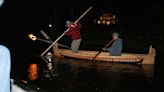 Torches and birchbark canoe guide Ojibwe man as he revives ancient tribal spearfishing tradition in northern Wisconsin