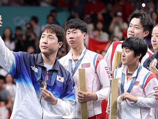 North, South Korea share podium, selfie in rare Olympic moment