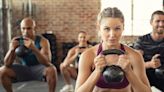 Lad at the gym put in awkward position as female friend squats in front of him