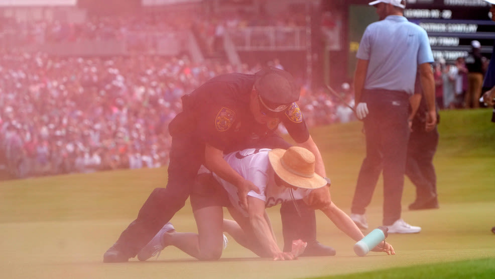 Climate activists interrupt PGA golf tournament, spray red and white powder onto course