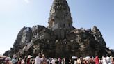 Fierce storm topples tree at Cambodian Angkor temple complex, killing 1 and damaging statues