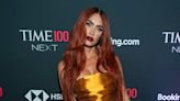 Megan Fox debuts fiery copper hair in figure-hugging gown with dramatic slit