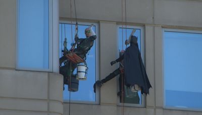 ‘It means everything’: Batman cleans windows, greets hospitalized children