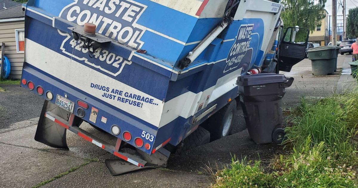 Waste Control truck falls in Longview sinkhole