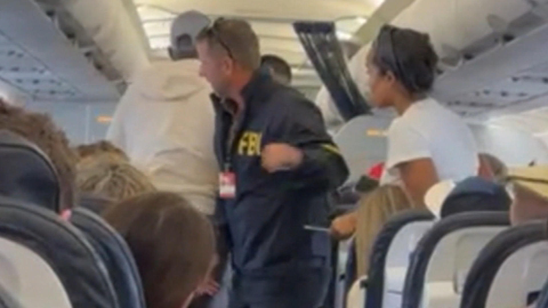 New video shows the moment Terrell Davis was handcuffed aboard flight