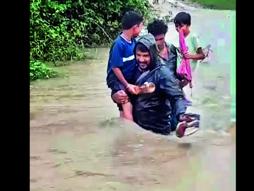 Teacher braves flooded stream, shifts kids to safety in Asifabad | Hyderabad News - Times of India