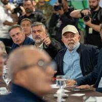 Brazilian President Luiz Inacio Lula da Silva (in hat) promised 'there will be no lack of human or material resources' to deal with the emergency