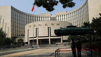 China's central bank cuts interest rates, moving to put more pep into the economy