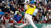 Rafael Devers of the Boston Red Sox follows through on his two-run double against the Washington Nationals during the eighth inning at Fenway Park on Saturday, May 11, 2024, in Boston.