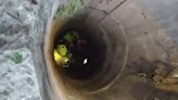 Man rappels down deep well to rescue python in Thailand