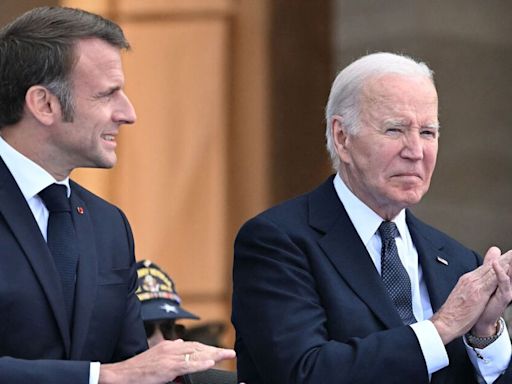 Shocking moment doddering Joe Biden helped by Emmanuel Macron at D-Day parade