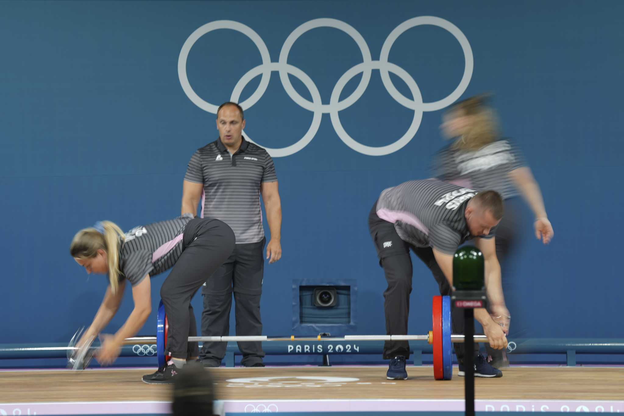 Like pit crews but in weightlifting. How loaders keep the Olympic sport going