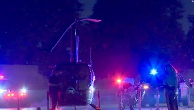 A helicopter halts traffic on the 110 Freeway in South Los Angeles