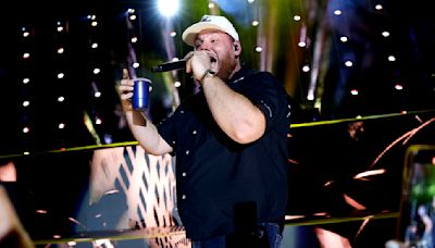 Watch Luke Combs Shotguns Beers With Glen Powell & ‘Twisters’ Co-Stars at NJ Concert