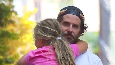 Bradley Cooper carries daughter Lea in his arms during stroll in NYC