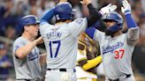 The Los Angeles Dodgers' Will Smith, left, and Shohei Ohtani congratulate Teoscar Hernandez after his grand slam during the sixth inning against the San Diego ...