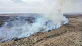 Firefighters face difficult weather conditions as they battle the largest wildfire in Texas history