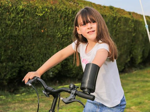 Watch: Eight-year-old girl giggles with delight as she test-drives new £20,000 bionic arm