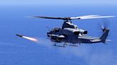 A US Marine Corps attack helicopter fired off a new 'fire and forget' missile for the first time in the Pacific, striking a moving vessel