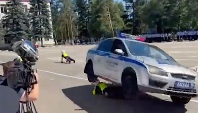 Shock moment police stunt goes horribly wrong as cop is crushed under car