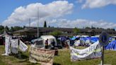 Hundreds of asylum-seekers are camped out near Seattle. There's a vacant motel next door