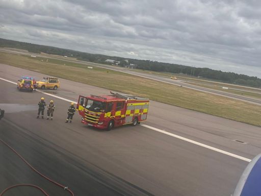 Gatwick chaos as firefighters seen hosing down plane on runway