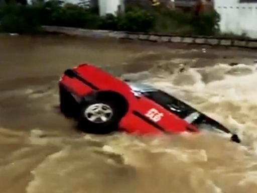 Hong Kong taxi driver and passenger escape as car plunges into sinkhole