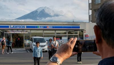 Sick of tourists, Japan town blocks view of Mt Fuji