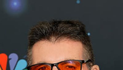 Why does Simon Cowell wear red-tinted glasses?