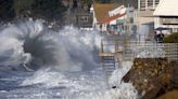 California beachgoers enthralled by huge waves from storms – but they bring flooding and rip currents, too