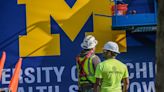U-M logo, sign hoisted to top of Michigan Avenue hospital to mark new owner