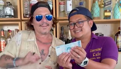 Johnny Depp Happily Samples a Drink Behind the Bar While Visiting a Restaurant in the Bahamas