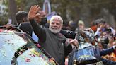 Indian PM Modi steals limelight at lavish Ambani wedding as route to the ceremony lined with posters