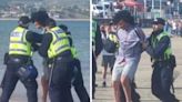 WATCH: Masked man arrested on beach - as officers praised for policing demo