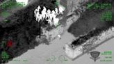 Infrared aerial video: Police officers form human chain to rescue injured suspect from Mass. river
