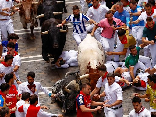 Pamplona bull-runners are tossed around and trampled