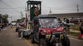 Crowds at a ‘redneck Christmas parade’ come up with one solution for their troubles: Trump