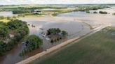 Rail bridge collapses during Midwest flooding as a heat wave persists across much of the US