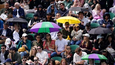 Heavy downpours suspend play on outdoor courts at Wimbledon