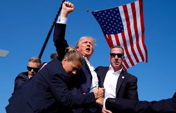 Bloodied face, fist raised in defiance: how this image may win Trump the US presidency