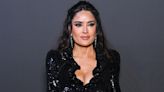 Salma Hayek's tie-dye look combines style and comfort as she cozies up to an unlikely pal