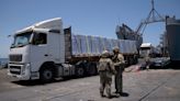 Off Gaza’s coast, truckloads of aid roll off a US military pier – only to remain uncollected | CNN