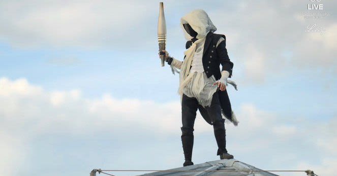 Yes, that’s an Assassin’s Creed character carrying the torch at the Paris opening ceremony